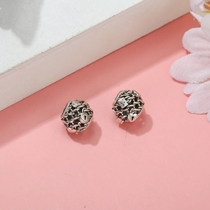 Detail of silver heart lock and key charms with woven texture for DIY charm bracelets