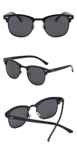 Close-up of retro clubmaster sunglasses with black frame and silver metal stud details