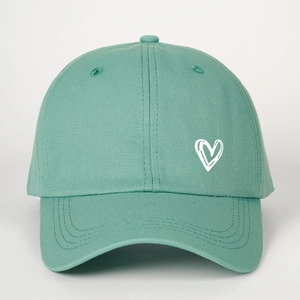 Close-up of mint green cotton baseball cap with white embroidered heart on the front