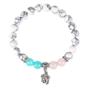 Beaded bracelet with white marble beads, blue and pink accents, and baby feet charm