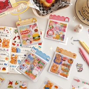 Flat lay of cute cartoon animal scrapbook stickers with colorful journal accessories