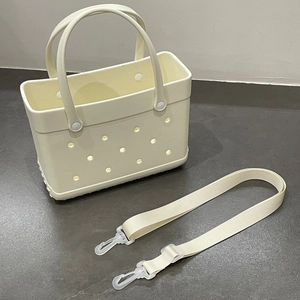 Detail view of off-white EVA beach tote with signature holes and detachable strap