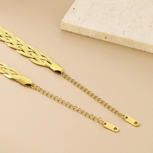 Detail of gold-plated stainless steel woven snake chain with extender and S.Steel tag