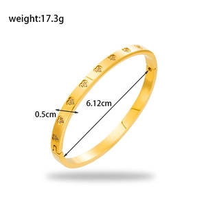 Gold stainless steel heart-shaped cutout bangle with pavé zircons in 45-degree angle view
