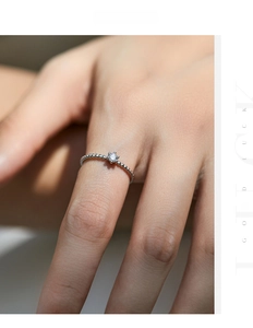 Close-up of s925 silver beaded ring with a sparkling moissanite in six-prong setting