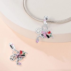 Dettaglio charm pistola in argento S925 con fiocco rosa e ciondolo della pace per bracciali