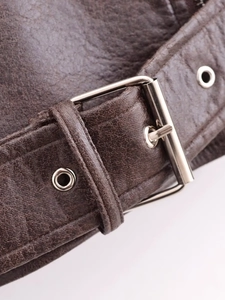 Macro detail of dark brown PU leather jacket with silver buckle and refined stitching