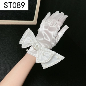 Close-up of white satin bridal glove featuring a large bow with pearl and silver bead accents