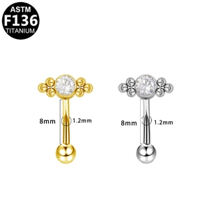 Macro detail of F136 titanium curved barbell with zircon stone and size indicators