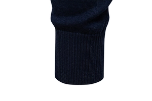 Detailed view of dark blue sweater cuffs showing high-quality knitted rib texture