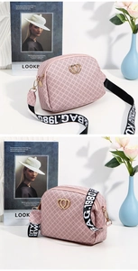 Pink synthetic leather crossbody bag with heart buckle and printed strap detail