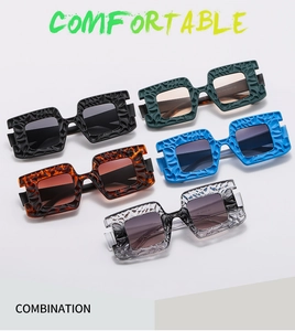 Detailed view of oversized square sunglasses with unique textured frame in multiple colors