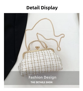 Detailed close-up of white tweed handbag with gold metal handle and kiss-lock clasp