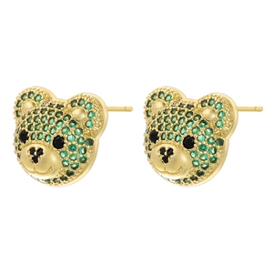 Detail of bear stud earring with green and black zircons in golden plated metal