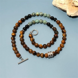 Top-down view of 8mm map stone and obsidian beaded necklace with a silver toggle clasp