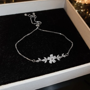 Macro shot of a floral zircon adjustable box chain bracelet in a black jewelry box