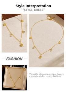 Detail of gold flower pendant necklace with crystal accents and heart-shaped chain tail