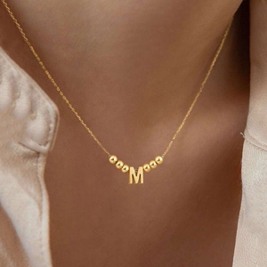 Minimalist gold letter M necklace for women featuring six decorative gold beads
