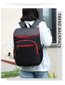Macro detail of the durable black insulated picnic backpack with stylish red zippers
