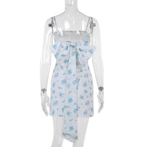 Detail view of a white floral dress with a large elegant blue flower bow on the back