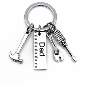 Detailed close-up of stainless steel keychain featuring dad tools like hammer and wrench