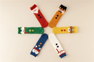 Detail view of 6 pairs of colorful coral fleece Christmas socks with festive character patterns