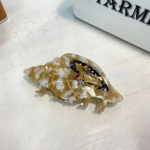Seashell acetate hair claw clip with amber stone texture and gold details