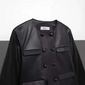 Short black faux leather jacket with double-breasted buttons and a round neck design