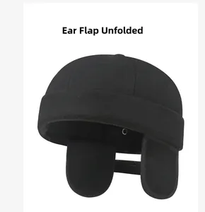 Detailed view of black wool docker hat with foldable earflaps in down position