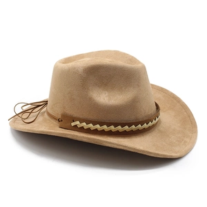 Detail of light brown suede cowboy hat with dark braided band and curved brim