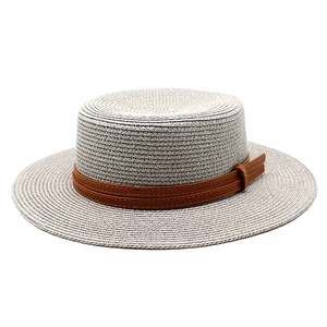 Detailed close-up of woven gray boater hat texture with brown faux leather decorative band