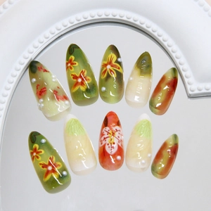 Floral tropical almond press-on nails with green gradients and 3D pearl accents
