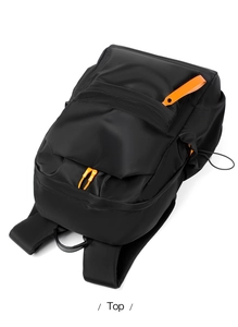 Top view of black waterproof backpack featuring vibrant orange zipper accents and nylon texture