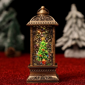 Close-up of bronze Christmas lantern with glitter snow and miniature tree inside