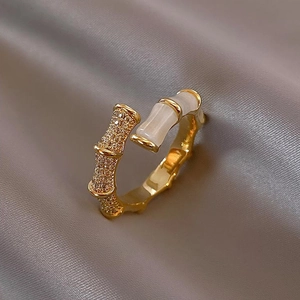 Elegant gold bamboo joint ring featuring micro-set zircon and white cat's eye stone accents