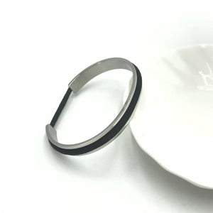 Detail of silver stainless steel cuff bracelet with integrated black hair tie holder