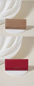 Detailed comparison of long leather wallets in camel and red with minimalist metal buckles