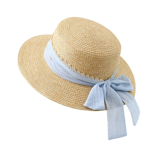 Elegant straw sun hat with light blue ribbon bow and lace trim for beach vacations