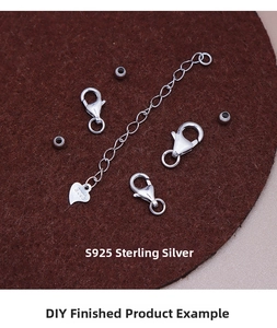 Macro shot of S925 sterling silver lobster clasps and heart charm extension chain