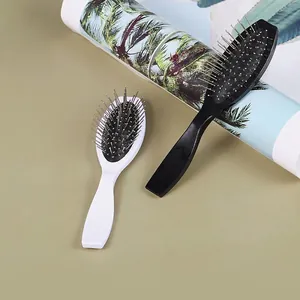 Oval hairbrush with steel pins and air cushion for wig care in black and white colors