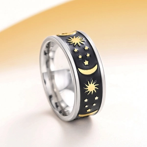 Macro shot of celestial celestial ring with gold moon stars over black enamel inlay