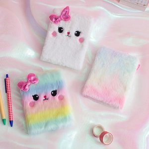 Detail of plush cat notebook with embroidered facial features and sequin bow decoration