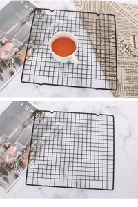Detail of black non-stick cooling rack with square mesh and curved edges for baking