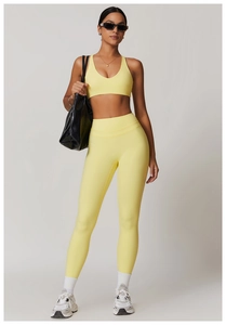 Detailed full-length view of the high-waisted yellow yoga set with sleek athletic cut