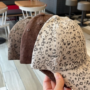 Detailed view of leopard print baseball cap with distressed worn texture and frayed edges