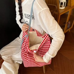 Detail of red checkered wool tote with magnetic closure and inner zipper pocket