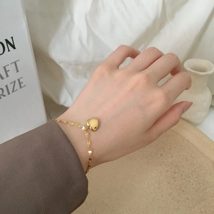 Elegant 18K gold-plated heart pendant bracelet on wrist with minimalist design