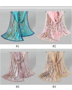 Detailed view of four sheer chiffon scarves with artistic floral prints in various colors