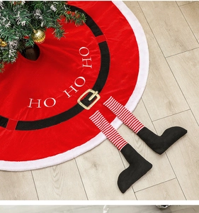 Detail of red Santa tree skirt with fuzzy white trim, striped legs and black boots