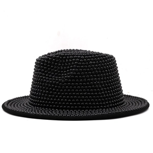Detail of elegant black boater hat featuring dense beadwork and textured pearl finish